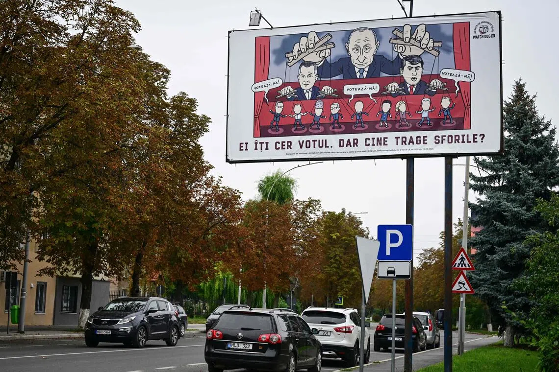 A billboard in Moldova showing a caricature of Russian President Vladimir Putin pulling the strings of various people ahead of the country's Sept 28 parliamentary election.