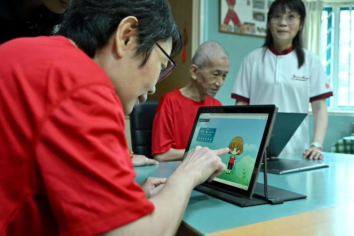 Ms Toh Siew Mui, 49, trying out a prototype of an AI-powered chatbot.