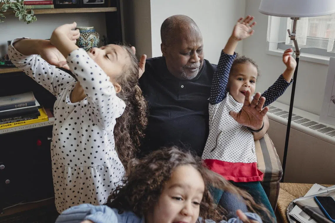 Mr Barry Sage-El, 69, who describes himself as “the master of the sleepover”, with his three granddaughters at his home in Montclair, New Jersey, Feb 27, 2023. 