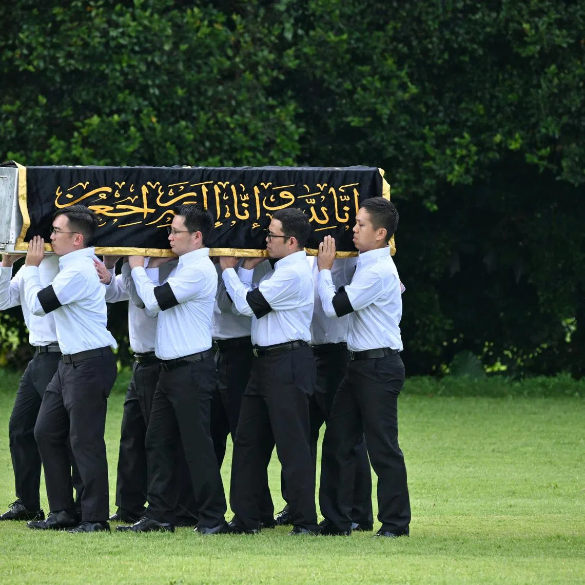Pallbearers carrying the casket of Puan Noor Aishah Mohammad Salim at Kranji State Cemetery on April 22.