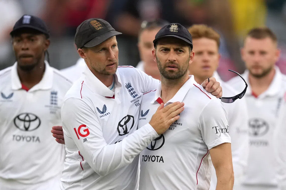 Cricket - The Ashes - Australia v England - First Test - Perth Stadium, Perth, Australia - November 22, 2025 England's Mark Wood and Joe Root look dejected after the match. REUTERS/Asanka Brendon Ratnayake