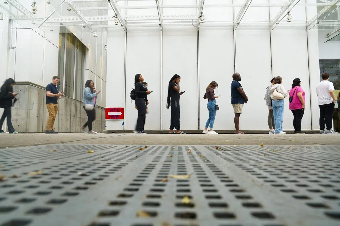 Voters head into a polling location to cast their ballots on the last day of early voting for the 2024 election on Nov 1 in Atlanta, Georgia. 