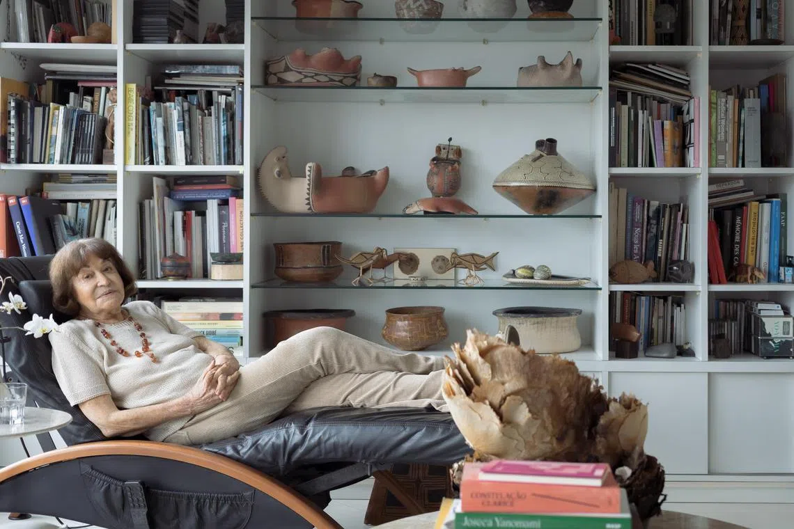 Claudia Andujar sits near her collection of ceramics, most of them made by indigenous peoples, at her apartment in Sao Paulo, Jan 19, 2023. 