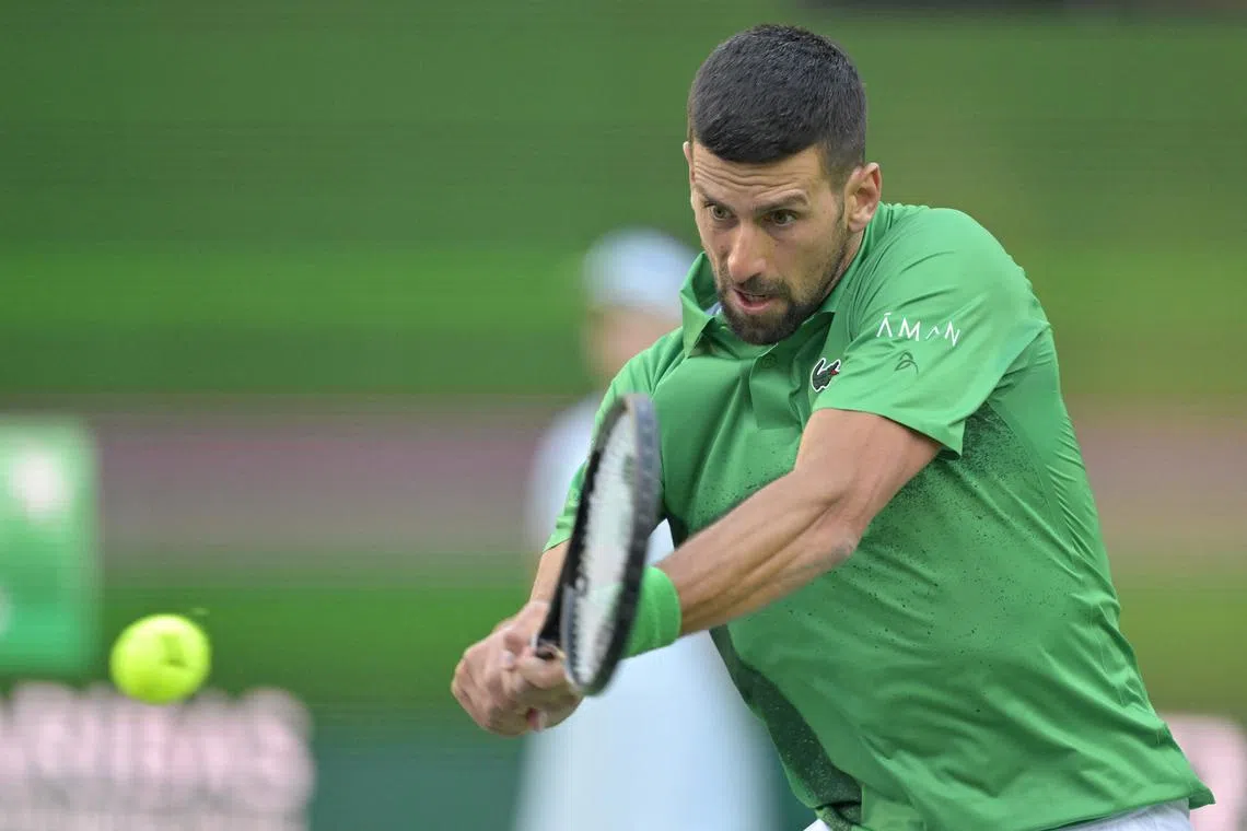 Mar 8, 2025; Indian Wells, CA, USA;  Novak Djokovic (SRB) hits a shot against Botic Van De Zandschulp (not pictured) during the second round of the BNP Paribas Open at the Indian Well Tennis Garden. Mandatory Credit: Jayne Kamin-Oncea-Imagn Images