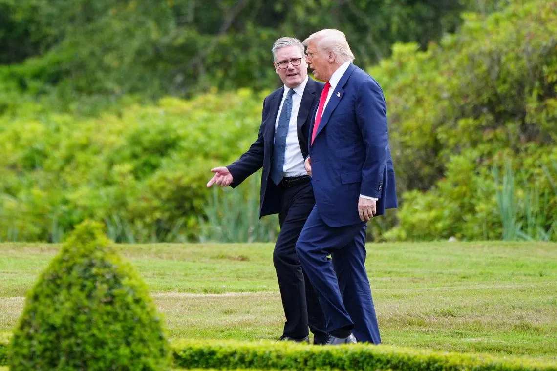 U.S. President Donald Trump walks with British Prime Minister Keir Starmer at Trump International Golf Links, in Aberdeen, Scotland, Britain, July 28, 2025.    Jane Barlow/Pool via REUTERS