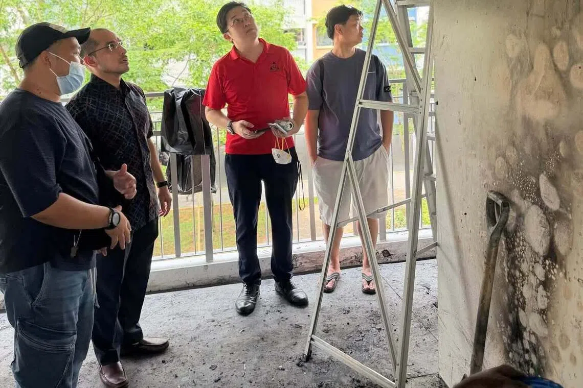 Nee Soon GRC MP Syed Harun Alhabsyi and grassroots leaders looking at the damage caused by the PMA fire on the third-floor landing of Block 438 Yishun Ave 11. No resident was injured.