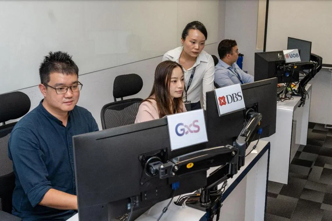 Anti-Scam Centre officers interacting with staff from the six partnering banks, during the two-month joint operation.