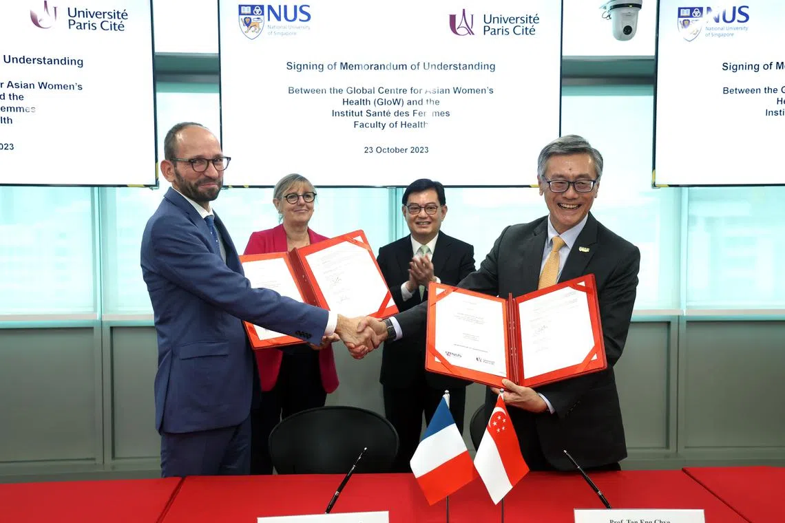 DPM Heng Swee Keat (second right) and France’s Minister of Higher Education and Research Sylvie Retailleau (second left) witnessing the signing of the MOU between NUS' Professor Tan Eng Chye and Universite Paris Cite's Professor Edouard Kaminski.