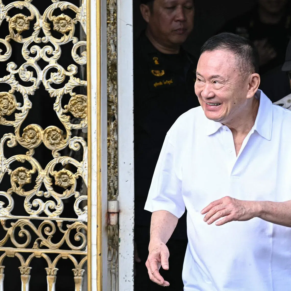 Thailand's former prime minister Thaksin Shinawatra is greeted by family members and relatives upon his release at Klong Prem Central Prison in Bangkok on May 11.