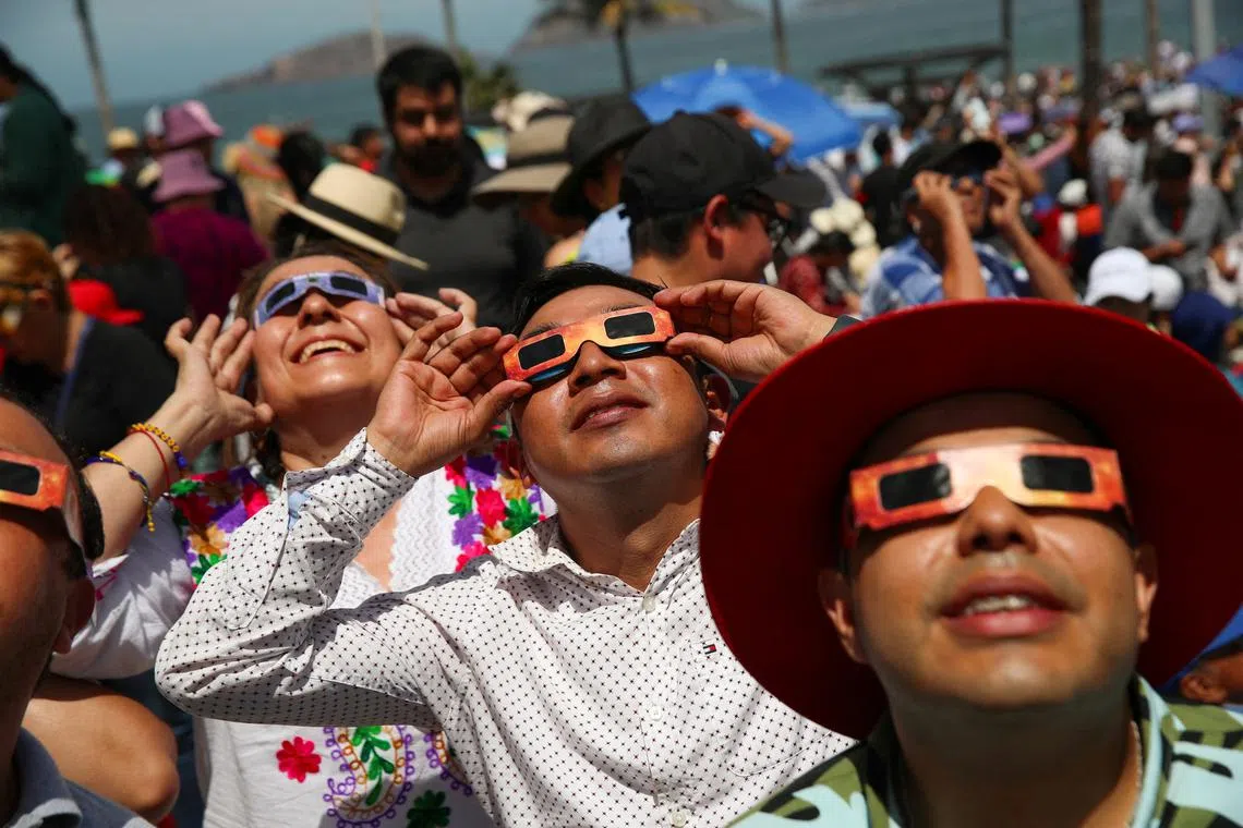 People observing the solar eclipse in Mazatlan, Mexico, on April 8, 2024. 