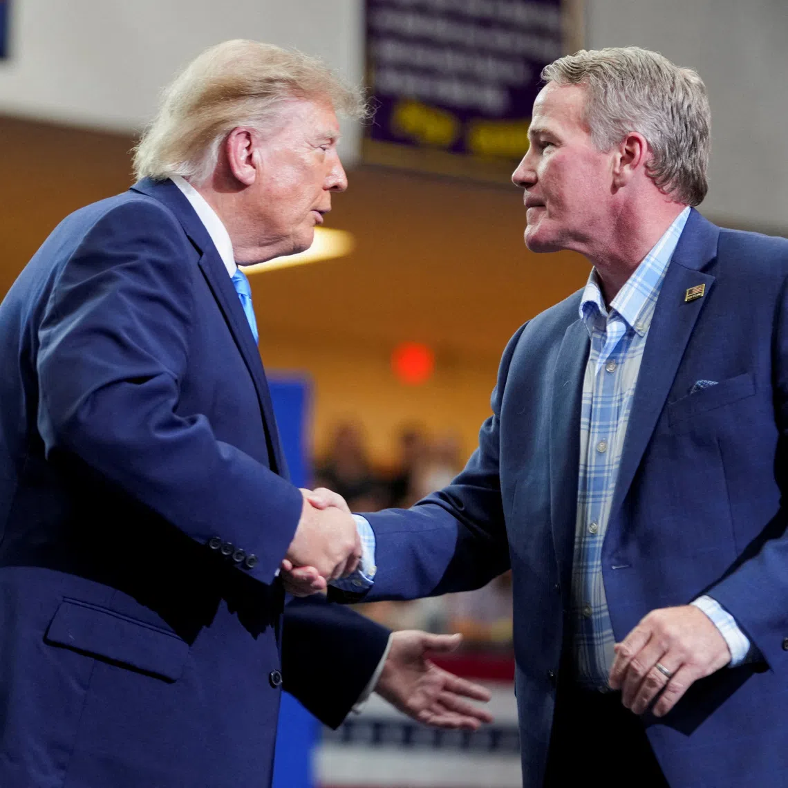 FILE PHOTO: Senator Jon Husted (R-OH) shakes hands with US President Donald Trump at a rally at Butler High School in Vandalia, Ohio, US, October 3, 2026. REUTERS/Nathan Howard/File Photo