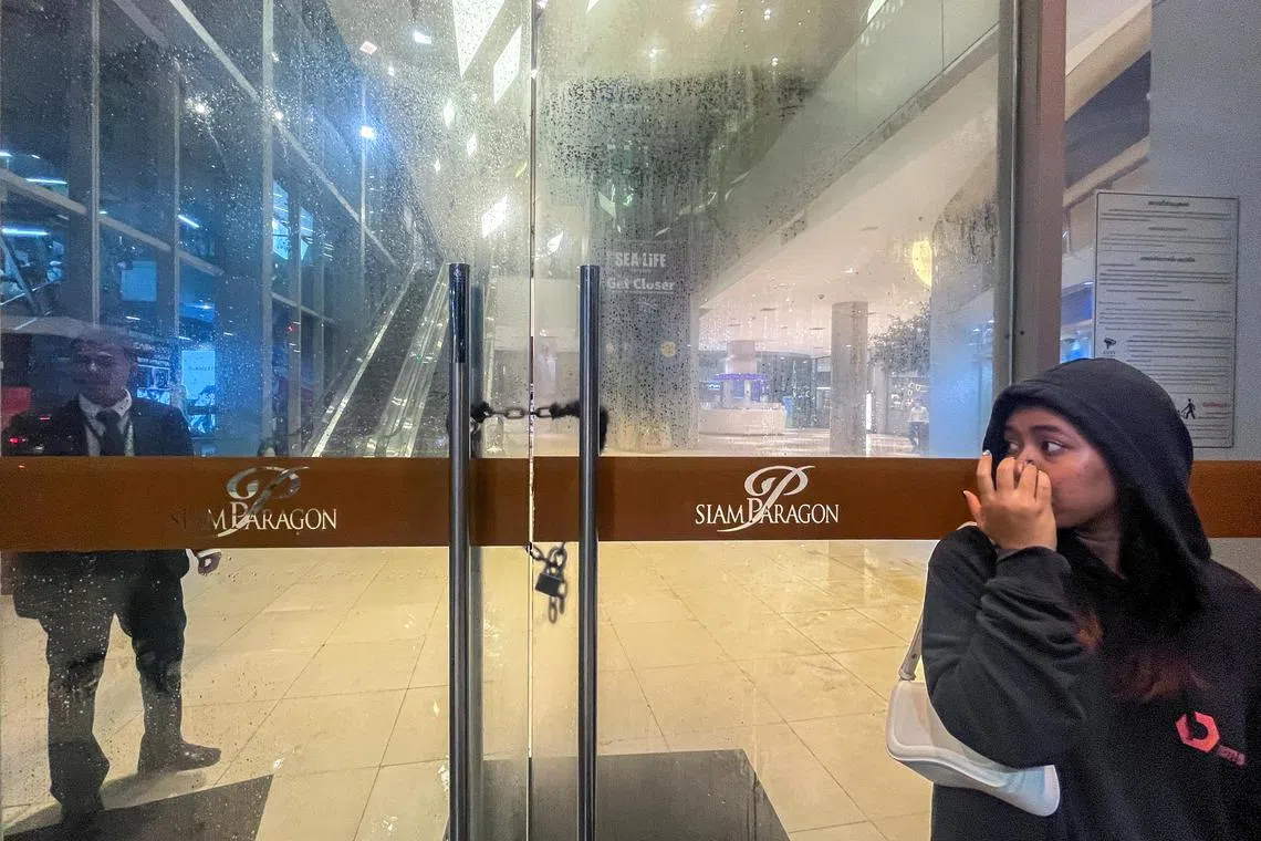 A security stands guard following shots fired at the luxury Siam Paragon shopping mall, in Bangkok, Thailand, October 3, 2023. 