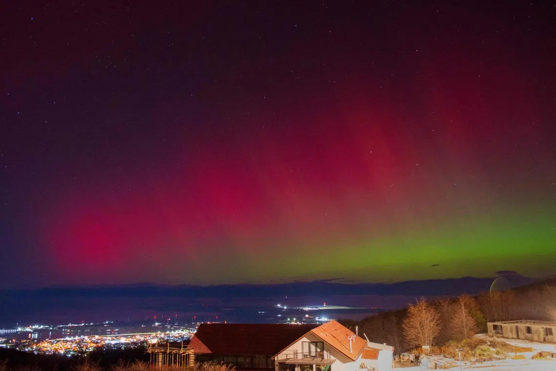 (FILES) The Aurora Australis, also known as the Southern Lights, glow on the horizon as seen from Ushuaia, Tierra del Fuego, Argentina on May 10, 2024. But solar activity is only just approaching the peak of a roughly 11-year cycle, so the odds of another major storm are highest "between now and the end of next year," Mike Bettwy of the US Space Weather Prediction Center said. (Photo by Alexis DELELISI / AFP)