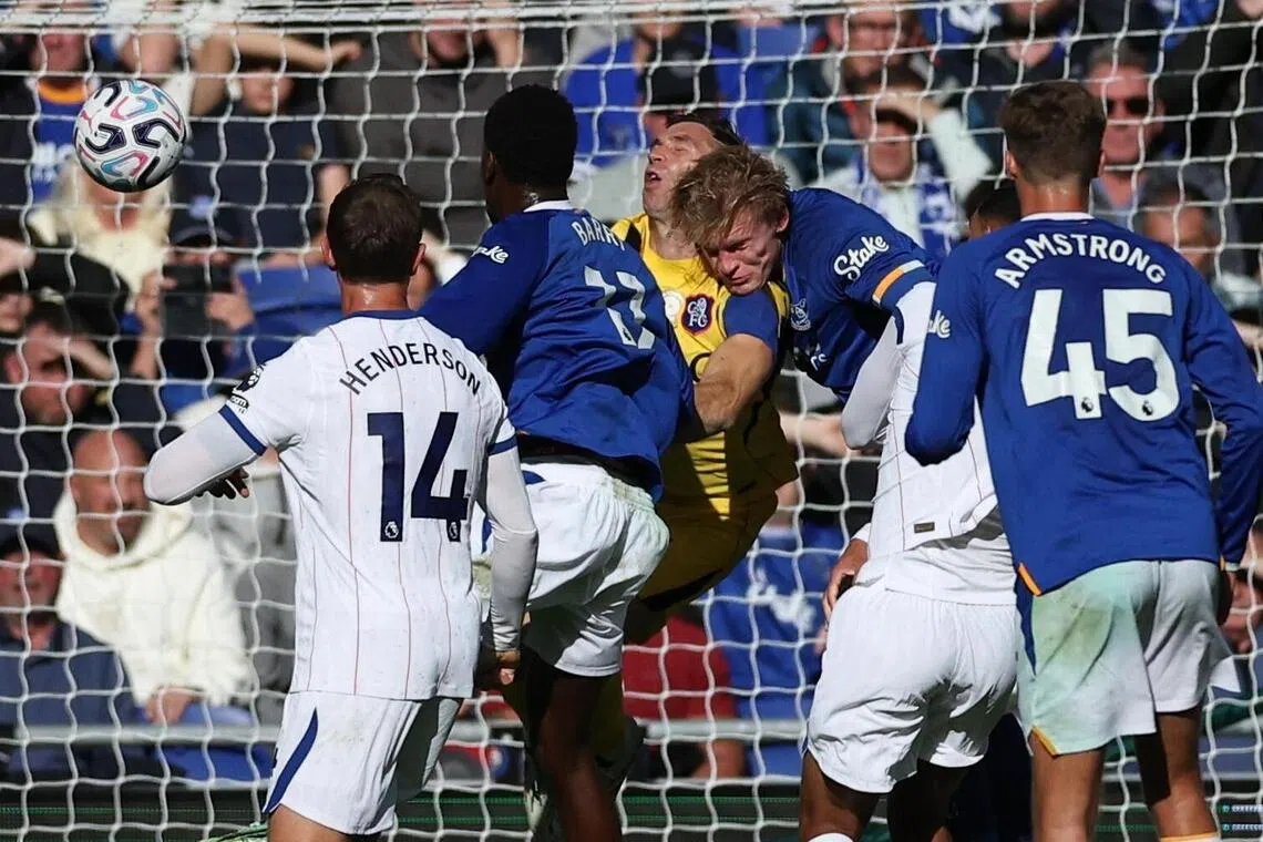 Emiliano Martinez of Chelsea (centre) clashes with Jarrad Branthwaite of Everton during their English Premier League match on Oct 17.