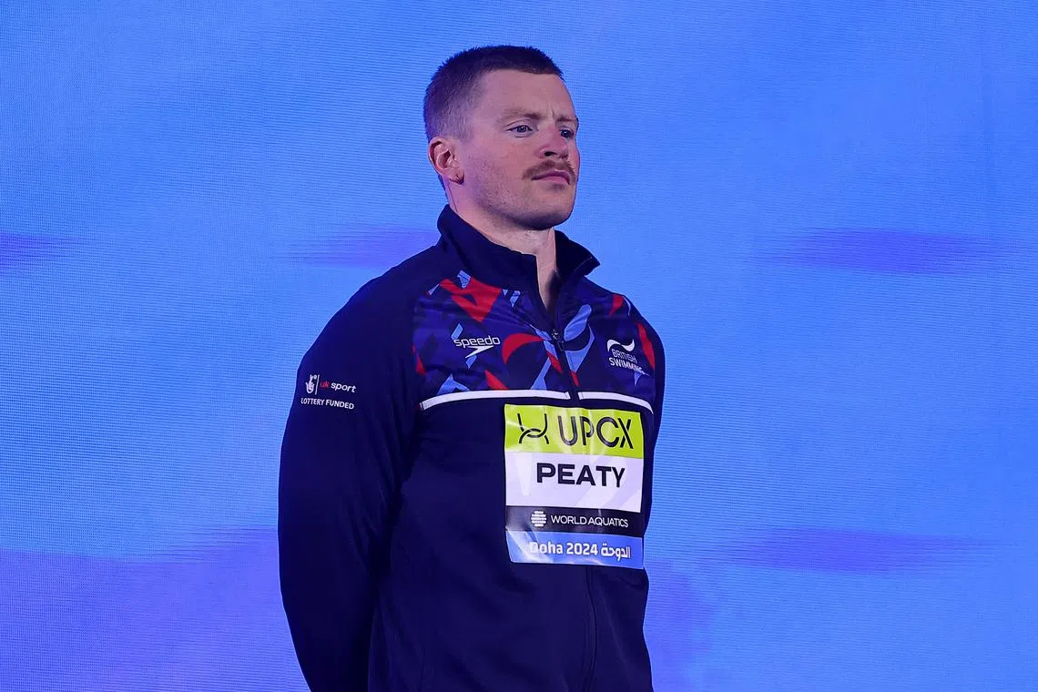 Swimming - World Aquatics Championships - Aspire Dome, Doha, Qatar - February 12, 2024 Britain's Adam Peaty on the podium after winning bronze in the Men's 100m breaststroke final REUTERS/Evgenia Novozhenina/ File Photo