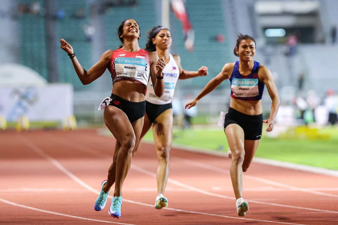 Singapore’s sprint queen Shanti Pereira raising her arms in ecstasy after retaining the women’s 100m title in 11.36sec at the Supachalasai National Stadium in Bangkok on Dec 11, with Thailand’s Khanonta Jirapat (in blue, 11.54) second and Vietnam’s Ha Thi Thu (not in picture, 11.58) third. Pereira went on to secure a historic double-double by winning the 200m two days later.