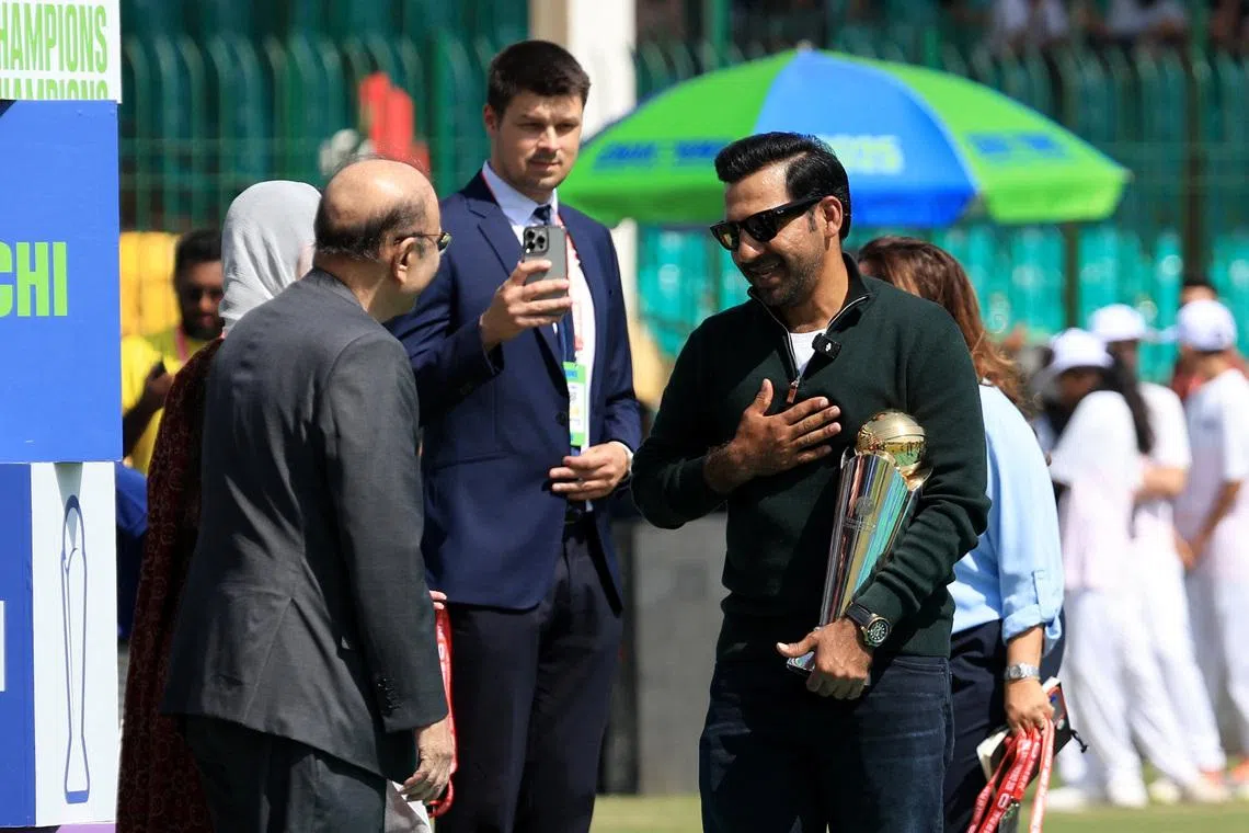 Cricket - ICC Men's Champions Trophy - Group A - Pakistan v New Zealand - National Stadium, Karachi, Pakistan - February 19, 2025 Former Pakistan cricketer Sarfaraz Ahmed with the trophy before the match REUTERS/Akhtar Soomro