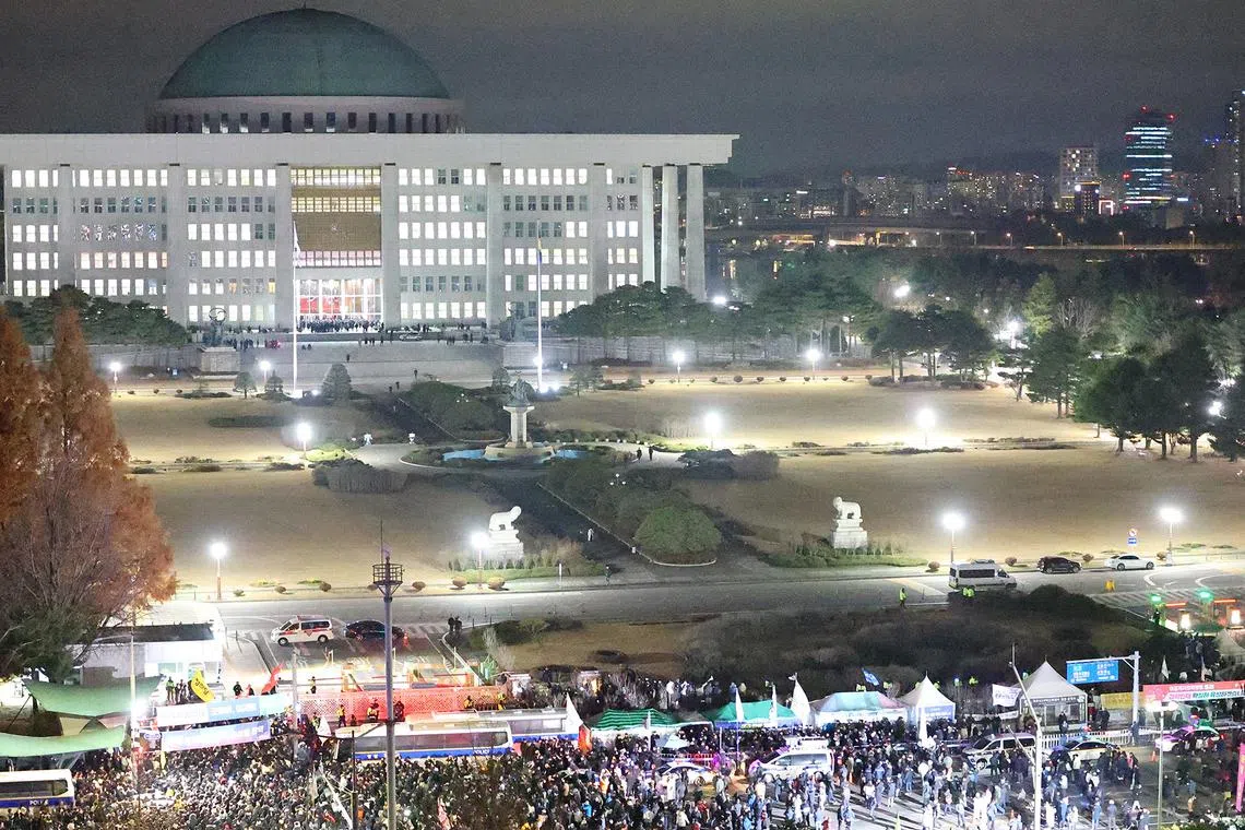 Police officers blocking protesters outside the National Assembly after South Korean President Yoon Suk Yeol declared martial law in Seoul, Dec 4, 2024. 