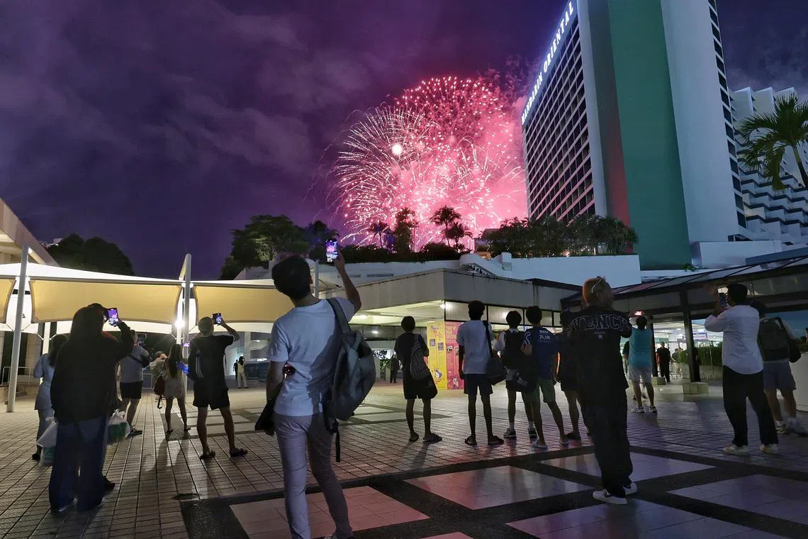 Fans watching the fireworks outside Marina Square at the conclusion of the Singapore Airlines Singapore Grand Prix   on Sept 22, 2024. 