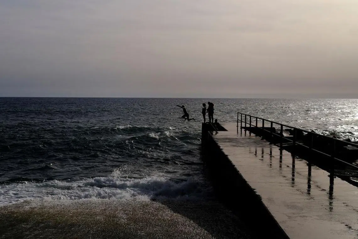 Pierre from Belgium, jumps into the Atlantic Ocean at Jardim do Mar on the Portuguese island of Madeira, Portugal October 7, 2023. REUTERS/Nacho Doce