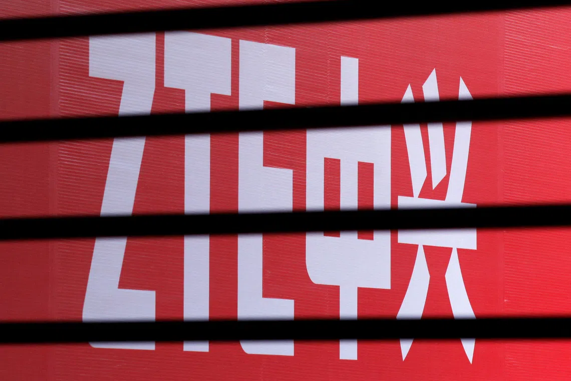 FILE PHOTO: The company logo of ZTE is seen through a wooden fence on a glass door during the company's 15th anniversary celebration in Beijing April 18, 2013.  REUTERS/Barry Huang/File Photo
