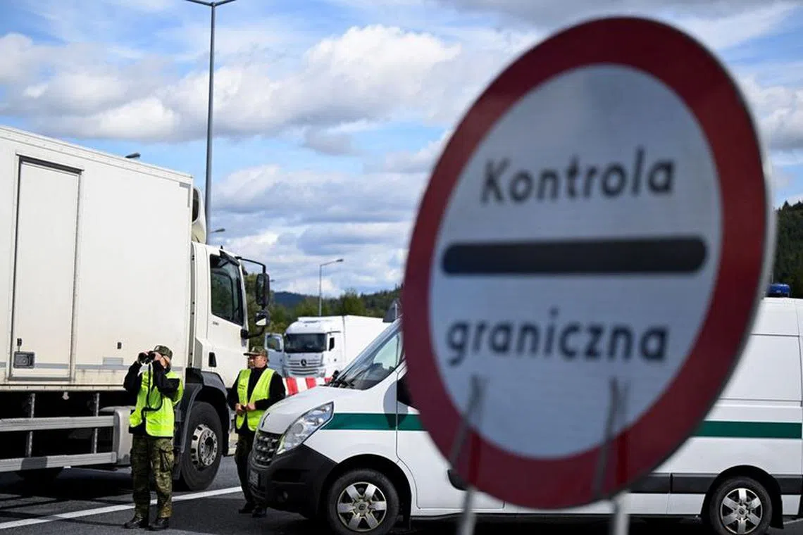 FILE PHOTO: Border guards patrol during vehicle checks at the Slovak-Polish border in Zwardon, Poland as part of security measures put in place to detect illegal migrants, October 4, 2023. REUTERS/Radovan Stoklasa/File Photo