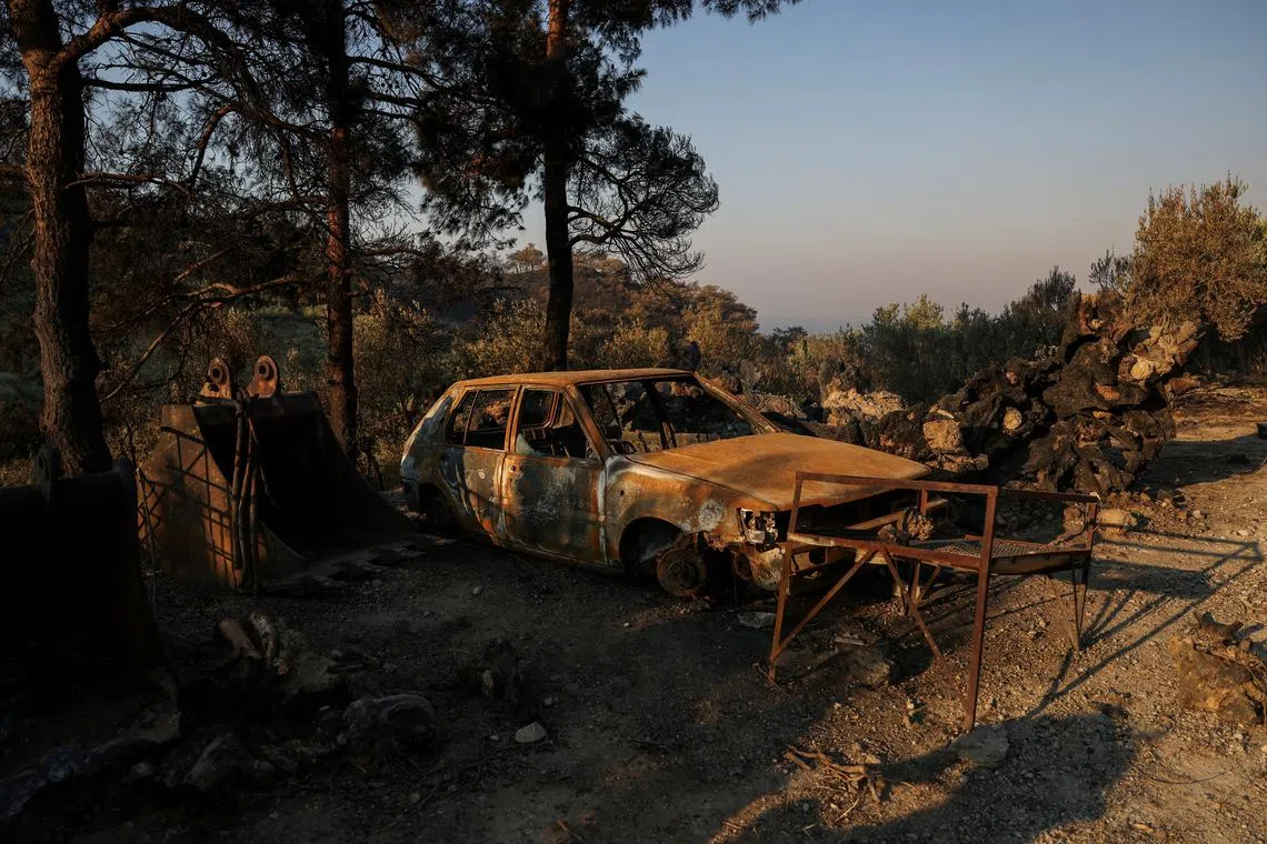 A destroyed car stands in the aftermath of a wildfire near Ierapetra, on the island of Crete, Greece, July 4, 2025. REUTERS/Alexandros Avramidis