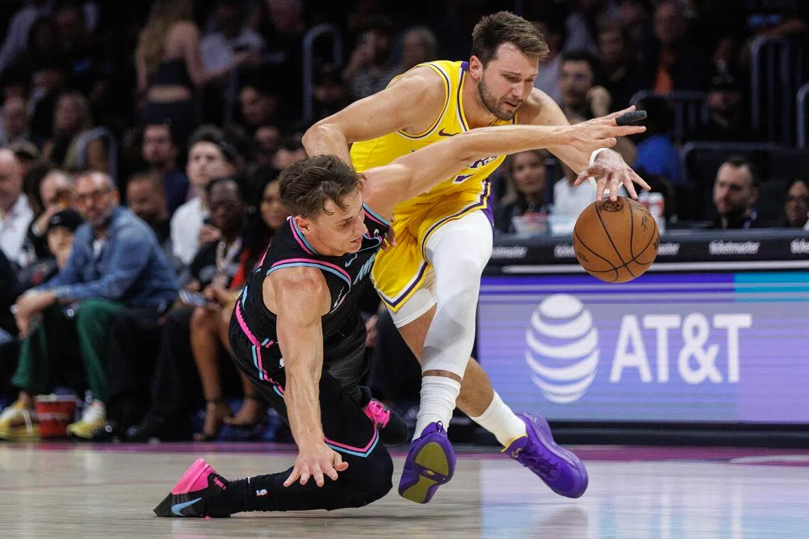 epa12835093 Miami Heat guard Pelle Larsson (L) in action against Los Angeles Lakers point guard Luka Doncic (R) during the NBA basketball game between the Miami Heat and the Los Angeles Lakers at the Kaseya Center in Miami, Florida, USA, 19 March 2026.  EPA/CRISTOBAL HERRERA-ULASHKEVICH  SHUTTERSTOCK OUT