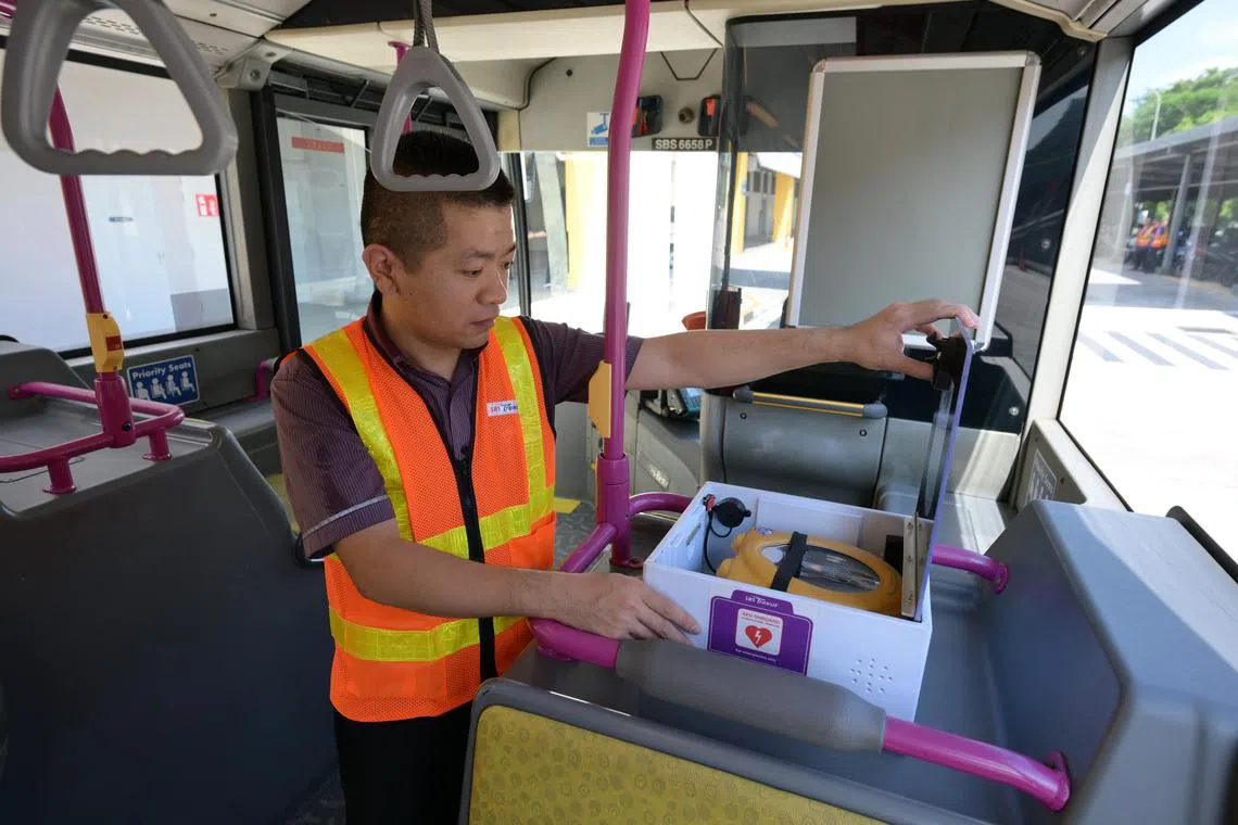Bus captain Chen Shaoxi with an Automated External Defibrillator? (AED) onboard bus 138.