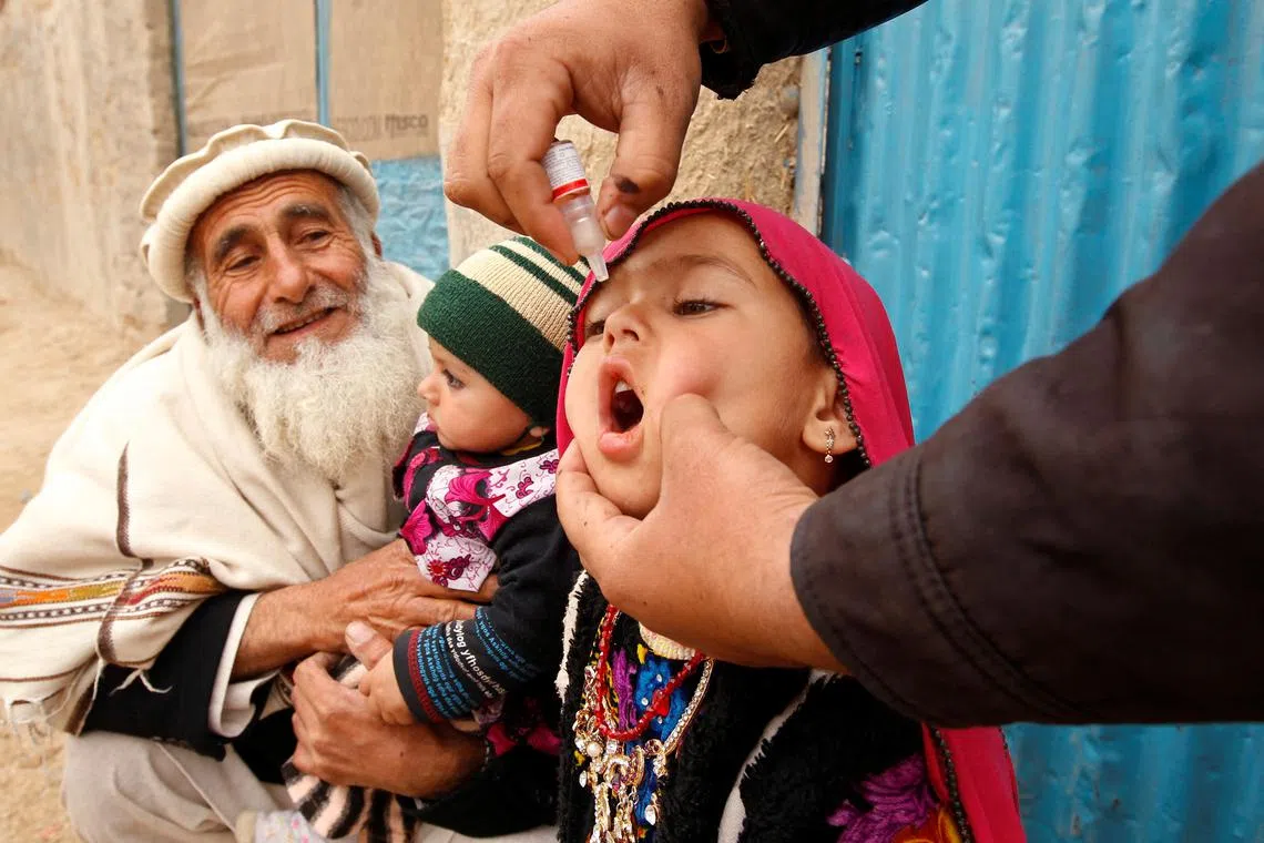 FILE PHOTO: A child receives a polio vaccination during an anti-polio campaign on the outskirts of Jalalabad, March 16, 2015.