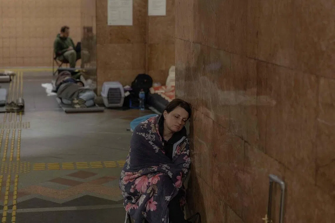 TOPSHOT - People take shelter at a metro station during Russian air attacks on Kyiv, early on July 2, 2026, amid the Russian invasion of Ukraine. Russian missile and drone strikes rocked Kyiv early on July 2, setting off fires and wounding at least five people, after President Volodymyr Zelensky warned that Moscow was preparing a "massive attack". Russia has routinely launched waves of missiles and drones at Ukrainian cities, including Kyiv, during its more than four-year invasion, which has become Europe's deadliest conflict since World War II. (Photo by Roman PILIPEY / AFP)