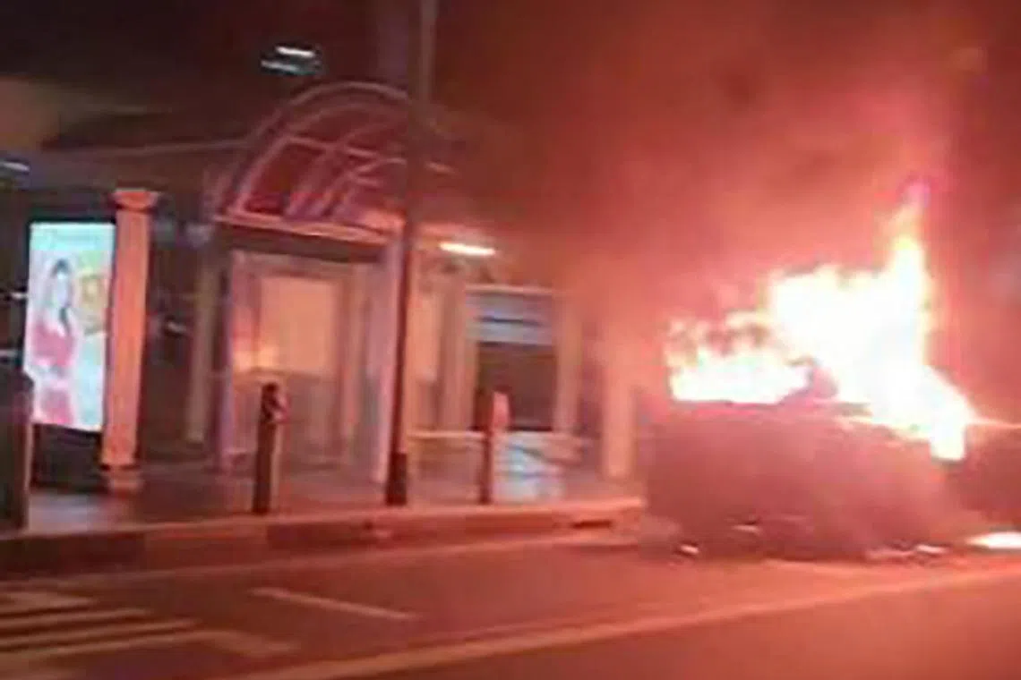 An electric hybrid car going up in a blaze in Victoria Street late last year.