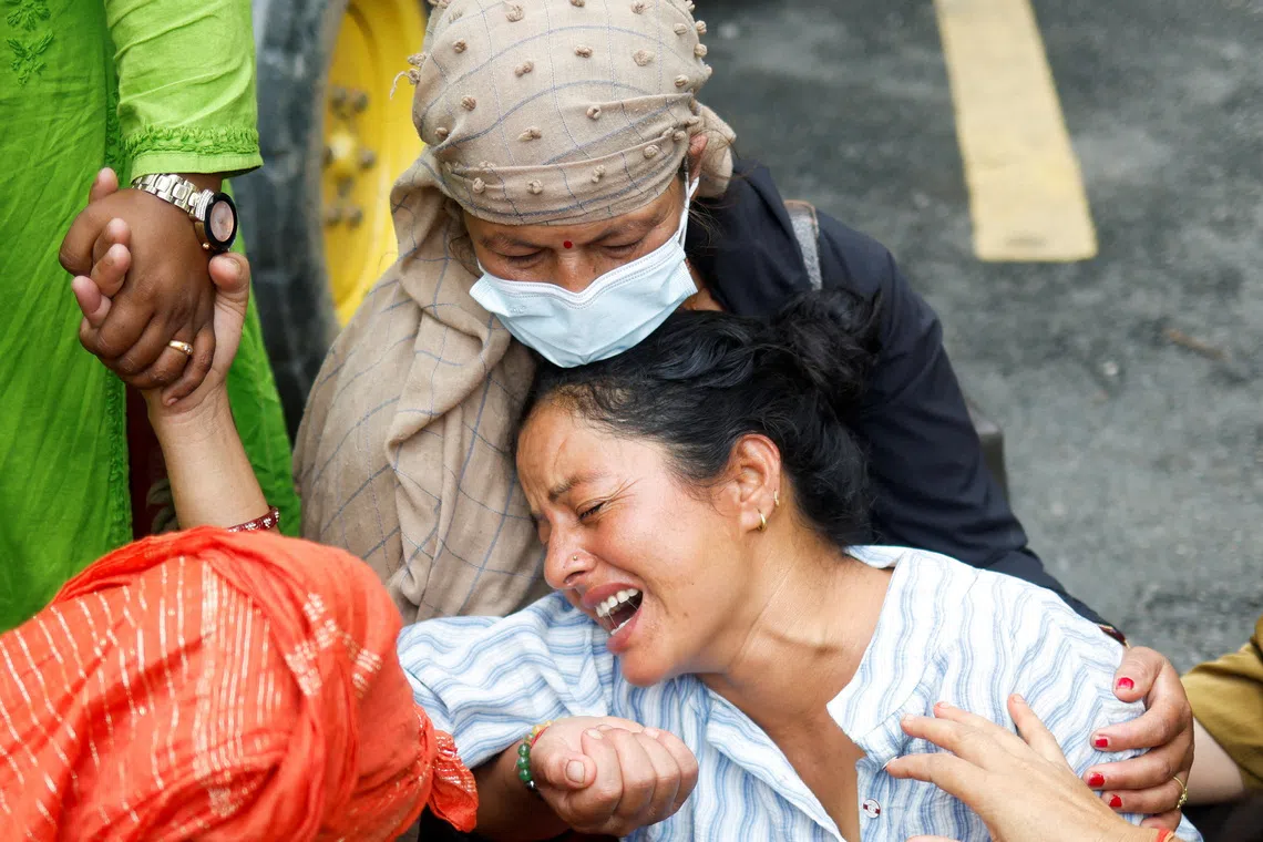 Muna Khadka, mother of Aayush Khadka, 21, who lost his life during the deadly flash floods and a mudslide, mourns outside a cremation ground, in Chitwan, Nepal, August 31, 2026. REUTERS/Adnan Abidi
