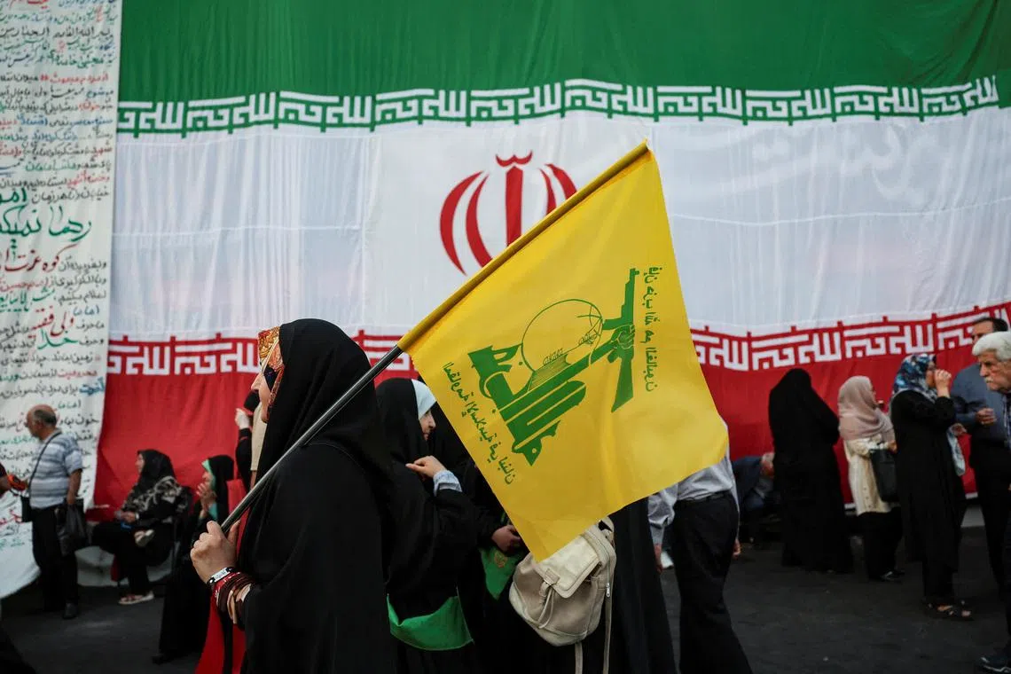 A woman holds a Hezbollah flag during a rally in support of Iran's Supreme Leader, Mojtaba Khamenei, in Tehran, Iran, June 4, 2026. Majid Asgaripour/WANA (West Asia News Agency) via REUTERS