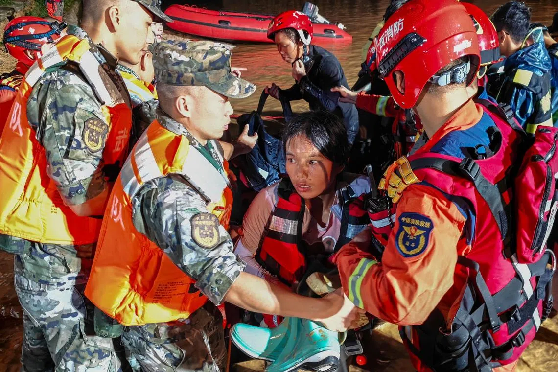 Rescue workers evacuate residents after heavy rainfall brought by Typhoon Maysak in Hengzhou, Guangxi Zhuang Autonomous Region, China, on July 6.