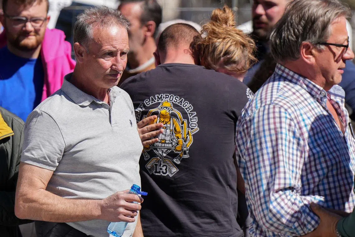 Family members and workers gathering on March 31 to await news following the blast.