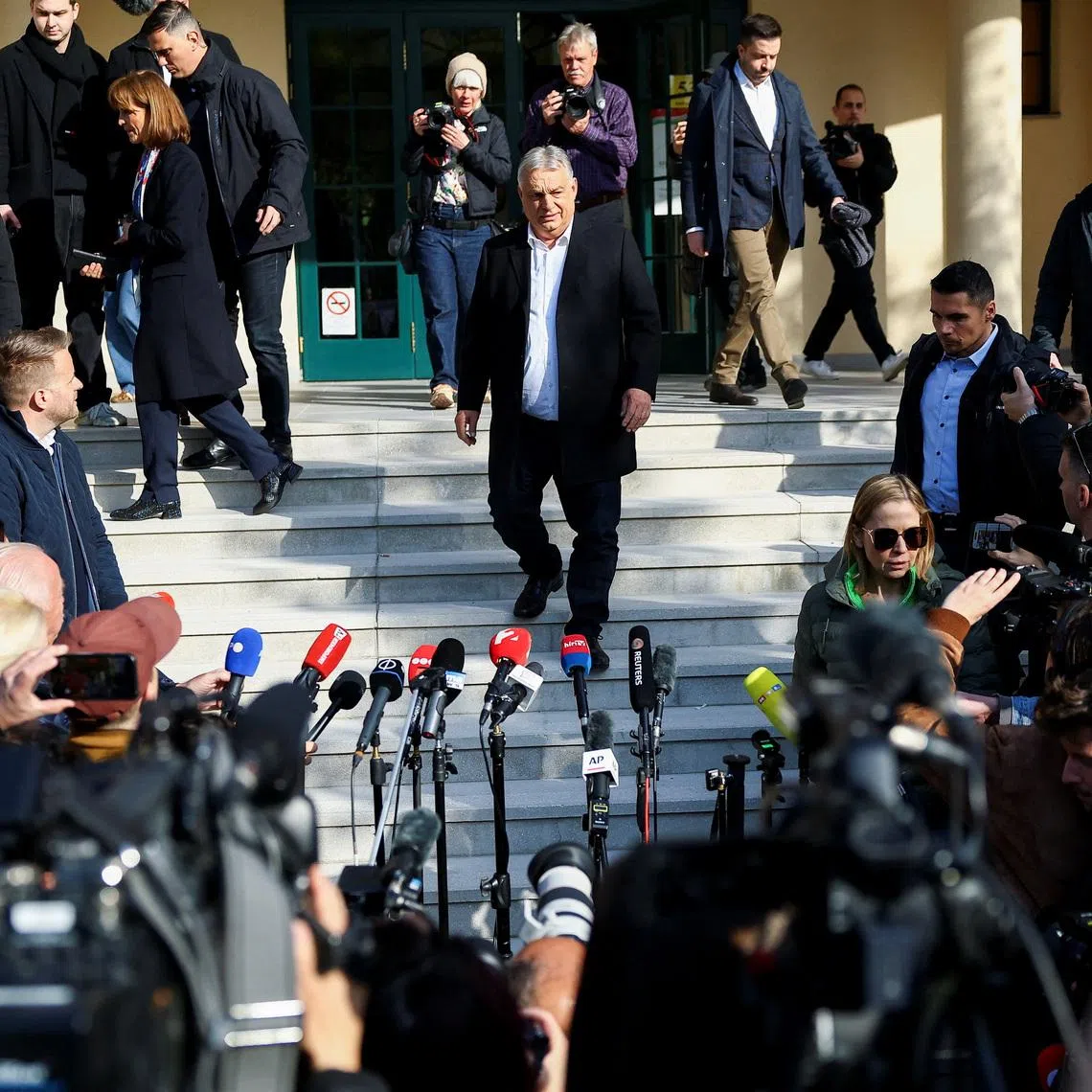 Hungarian Prime Minister Viktor Orban walks to talk to journalists after casting his vote during the Hungarian parliamentary election in Budapest, Hungary, April 12, 2026. REUTERS/Lisi Niesner