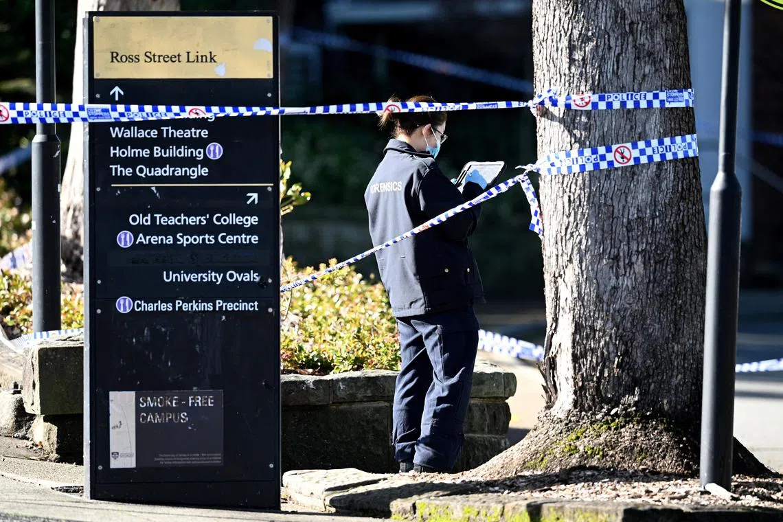A member of the New South Wales law enforcement team works at the scene of an alleged stabbing at the University of Sydney, on July 2.