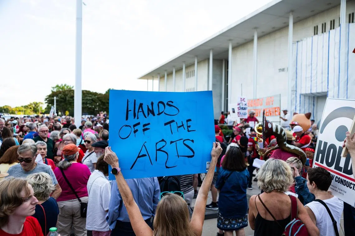 Crowds waved placards reading “hands off Kennedy Center” and broke out into song.