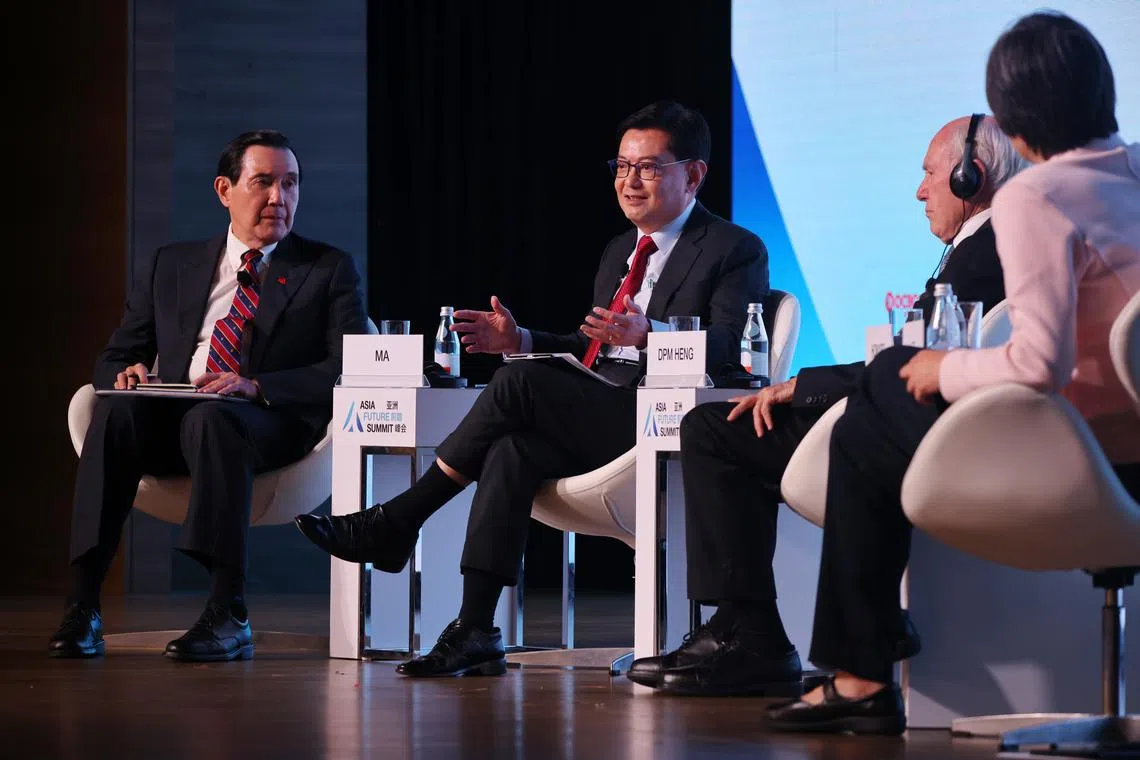 DPM Heng Swee Keat (second from left) speaking on a panel at the Asia Future Summit 2023. The other panellists were former Taiwanese president Ma Ying-jeou (left) and former Australian prime minister John Howard.