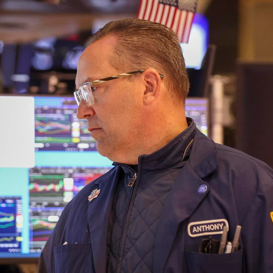 A trader working on the New York Stock Exchange floor after the opening bell on May 8.