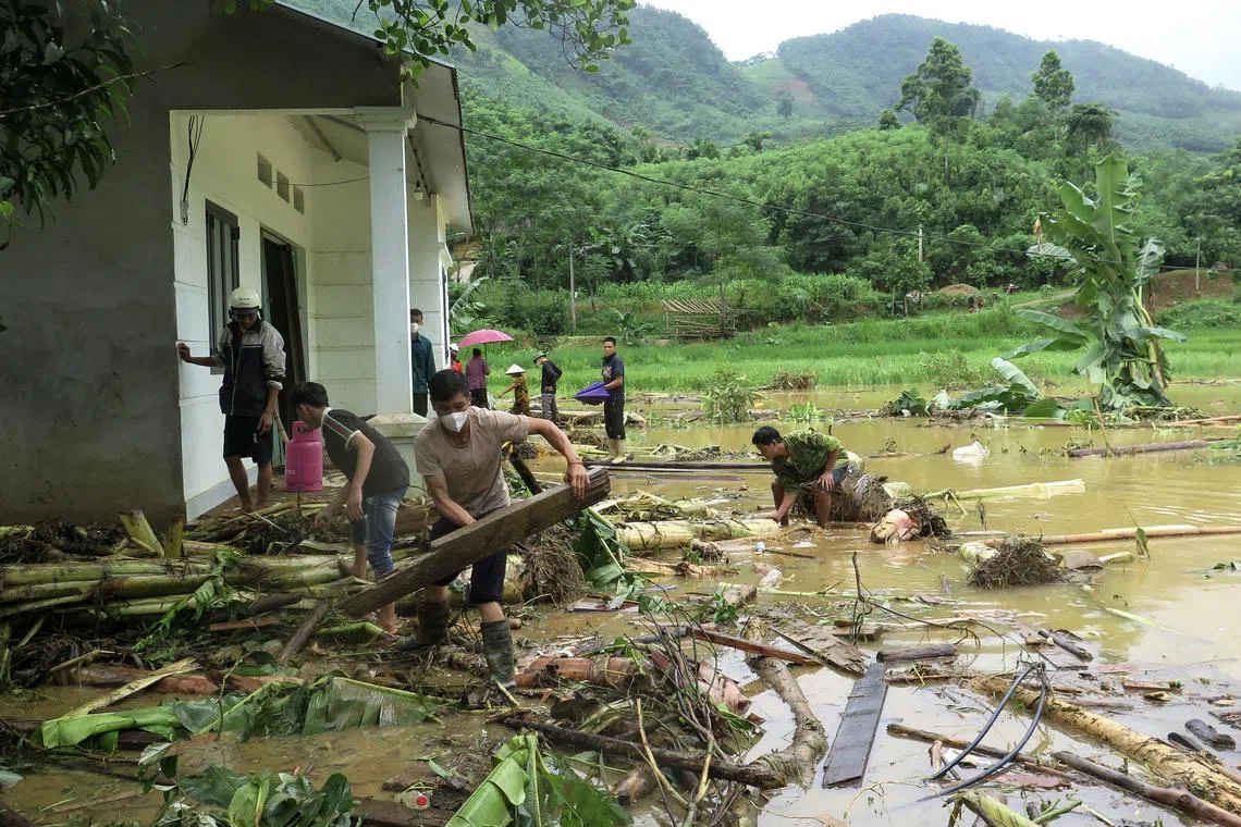 People take part in a search and rescue operation after a landslide hit the Lang Nu village, in the Lao Cai province, Vietnam, on Sept 11, 2024. 