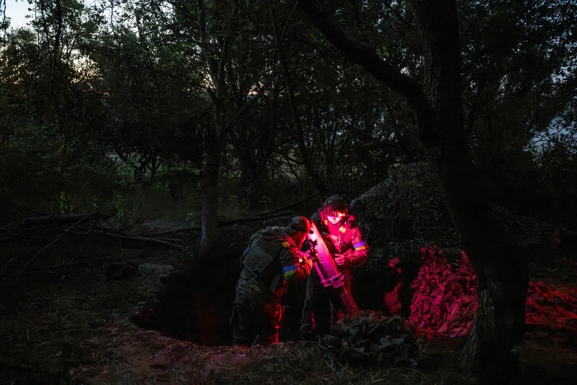 Artillerymen of the 13th Operative Purpose Brigade of the National Guard of Ukraine firing a 120mm mortar towards Russian troops, near the village of Lyptsi in Kharkiv region, Ukraine, on June 19, 2024. 