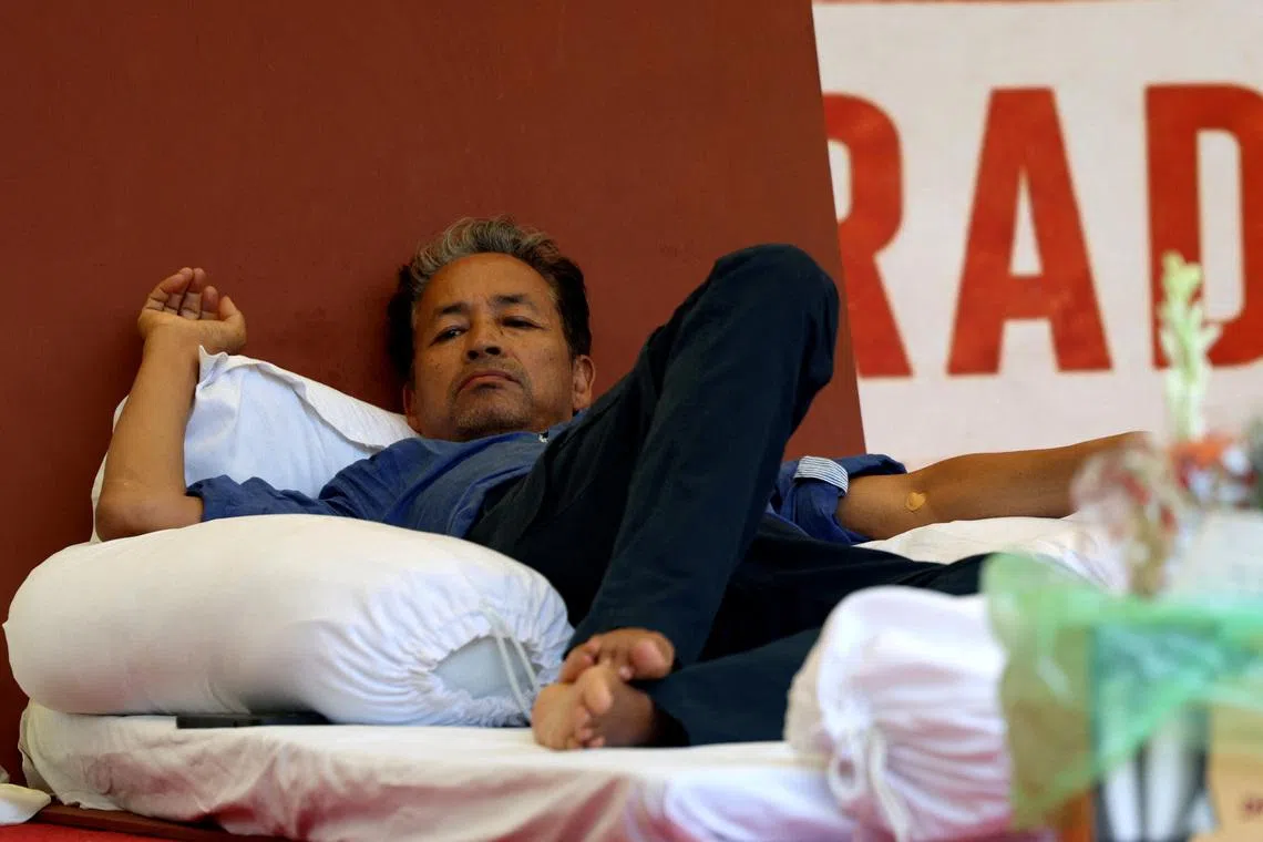 Sonam Wangchuk, an Indian education reformer, who has been on hunger strike, rests on stage during a sit-in protest called by CJP demanding the resignation of Indian Education Minister Dharmendra Pradhan, at Jantar Mantar in New Delhi, India, on July 14.