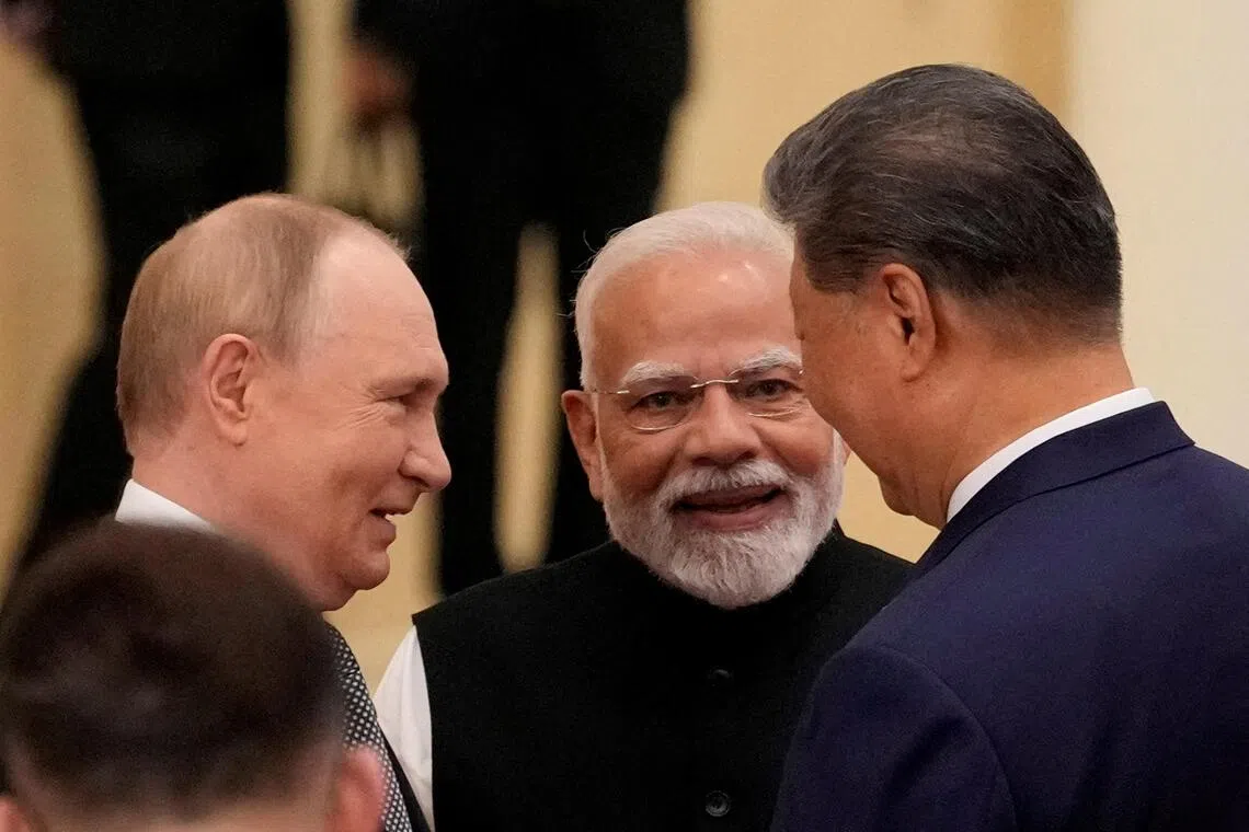 FILE PHOTO: Indian Prime Minister Narendra Modi talks with Russian President Vladimir Putin and Chinese President Xi Jinping ahead of the Shanghai Cooperation Organization (SCO) Summit 2025 at the Meijiang Convention and Exhibition Centre in Tianjin, China, September 1, 2025.  SUO TAKEKUMA/Pool via REUTERS/File Photo