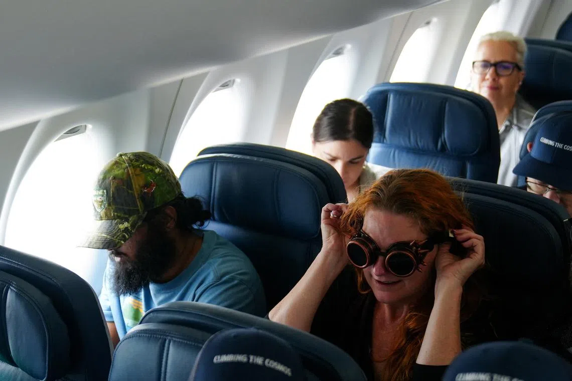 Passengers sitting in a special Delta Airlines eclipse flight, on the day of a total solar eclipse, in Austin, Texas, on April 8, 2024. 