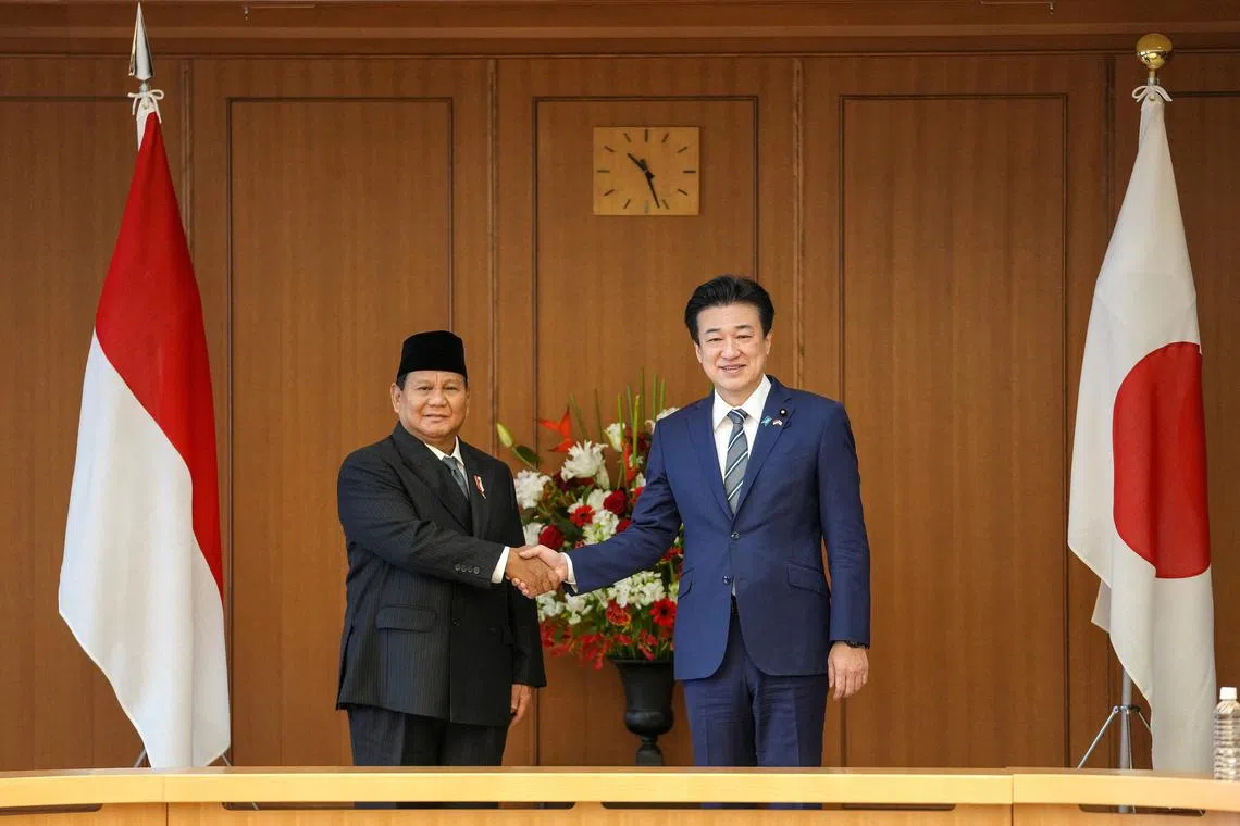 Indonesian Defense Minister and President-elect Prabowo Subianto and Japanese Defense Minister Minoru Kihara (R) shake hands at the start of their talks at the Defense Ministry in Tokyo, Japan, April 3 2024.   KIMIMASA MAYAMA/Pool via REUTERS
