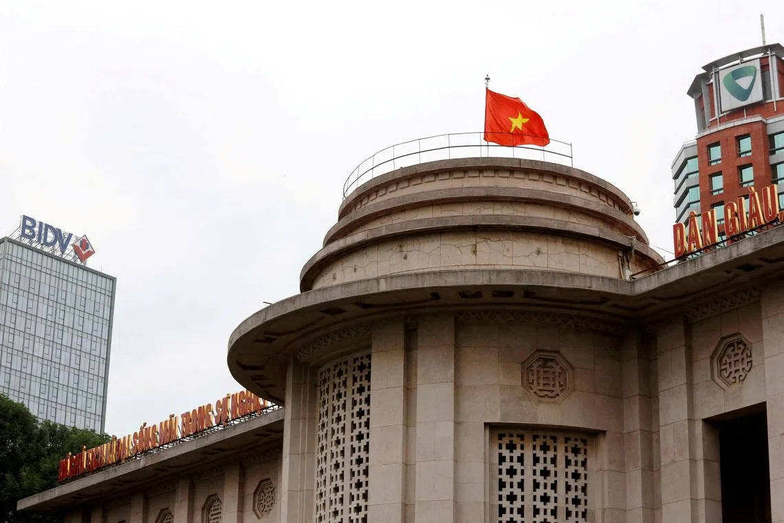 A Vietnamese flag flies atop the State Bank building on November 23, 2017.