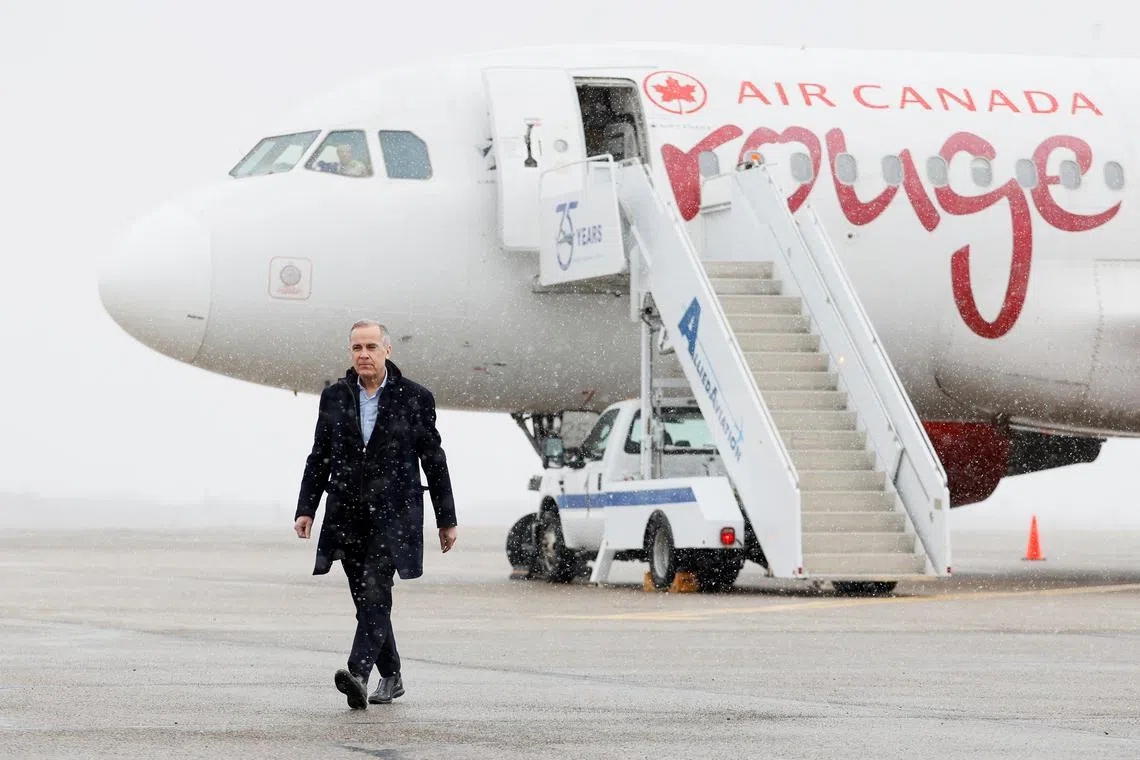 Canada's Prime Minister Mark Carney walks across the tarmac, on day two of his Liberal Party election campaign tour, at Gander International Airport in Gander, Newfoundland, Canada March 24, 2025. REUTERS/Blair Gable/File Photo
