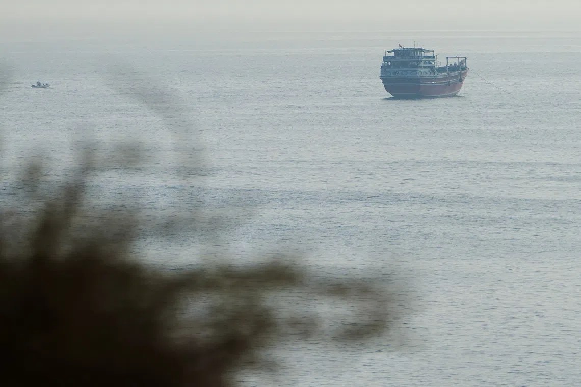 A large ship sailing on the water under a cloudy sky.